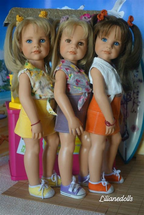Three Dolls Are Standing Next To Each Other In Front Of A Wall With An