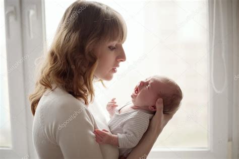Young Mother With Crying Baby — Stock Photo © Ababaka 58879983
