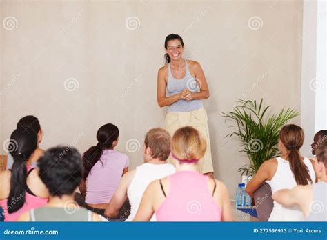 She Motivates Them Everytime A Yoga Instructor Smiling Happily At Her Class Stock Image