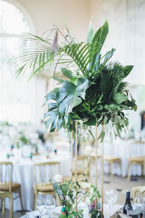 Tropical Table Centrepieces Sat Atop Elegant Gold Geo Stands Monstera