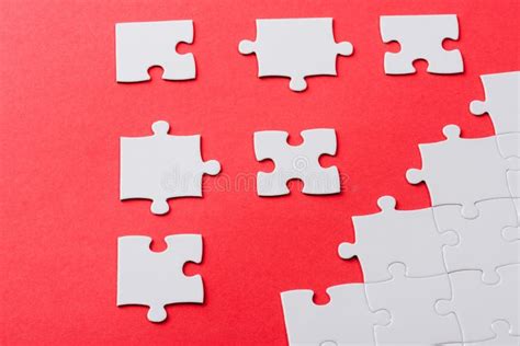Connected And Separate Jigsaw Puzzle Pieces Isolated On Red Stock Image