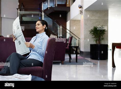 Business Woman Reading Newspaper In Hotel Lobby Stock Photo Alamy