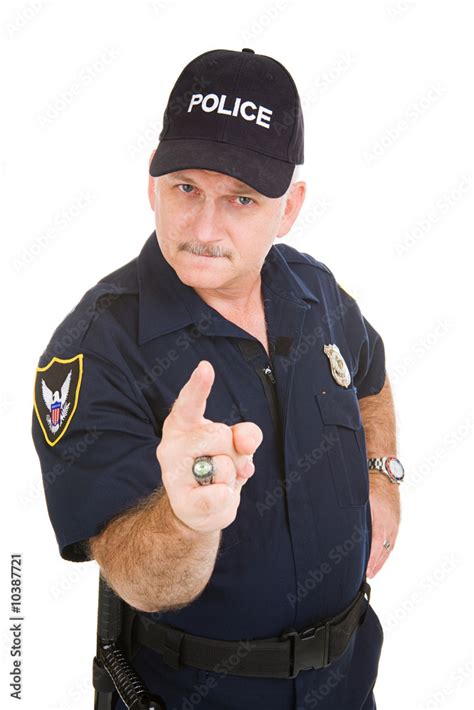 Angry Looking Police Officer Pointing His Finger At You Stock Photo