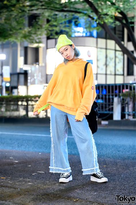 harajuku girl in resale street style w cav empt hoodie neon belt raw edge jeans and converse