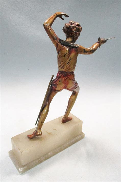 An Art Deco Cold Painted Figure Of A Female Fencer Standing En Garde Mounted To An Onyx Plinth