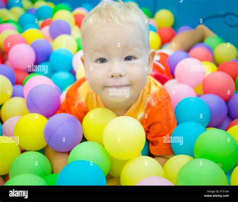Cute Kid Boy Playing With Colorful Balls Stock Photo Alamy