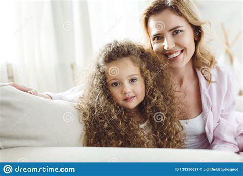 happy mother and adorable curly daughter looking stock image image of