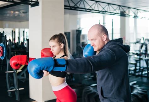 Premium Photo Couple Exercising Punching A Young Woman And A Man Are Training Punches In