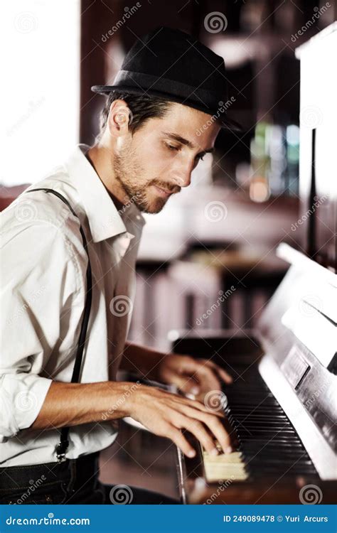 Expressing The Music From Deep Within His Soul A Handsome Young Man Playing The Piano In A Club