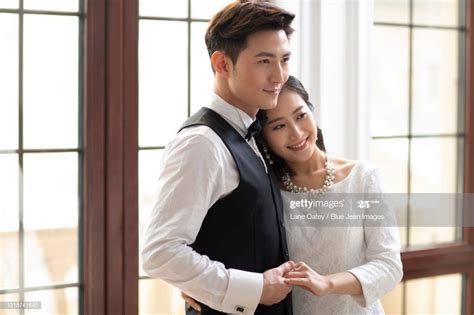 Happy Young Chinese Couple Embracing At Home Couples Photographers