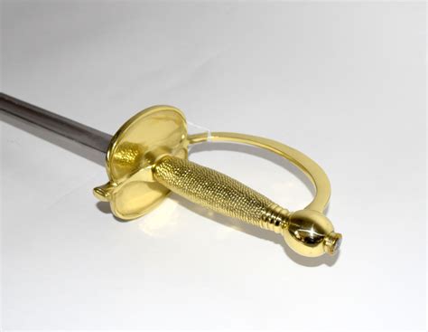 A Single Edged Sword With Gilt Hilt And Knuckle Guard In Its Scabbard