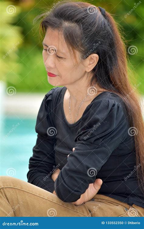 Unhappy Filipina Female Senior Stock Photo Image Of Bored Elder