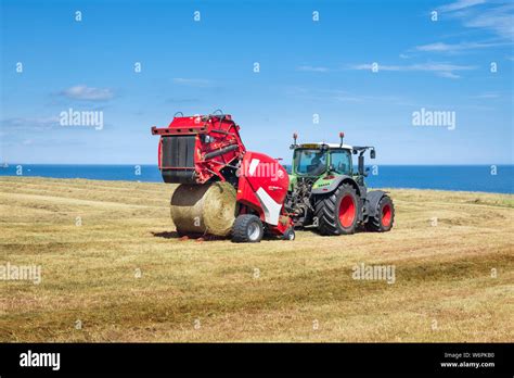 Modern Farming Machinery A Farmer In Tractor Making Circular Hay