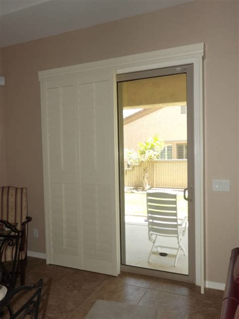 When rolled up, the system blends in with the door's trim for a seamless look. Plantation Shutters on sliding glass doors - Traditional ...
