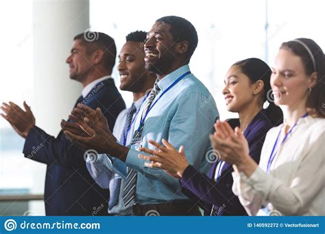 Happy Business People Applauding In A Business Seminar Stock Photo
