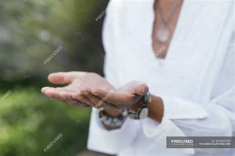 Close Up Of Hands Of Woman Practicing Virtue Of Giving Hand Gesture
