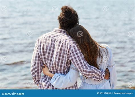 Young Couple Embracing By Lake Stock Photo Image Of Intercultural
