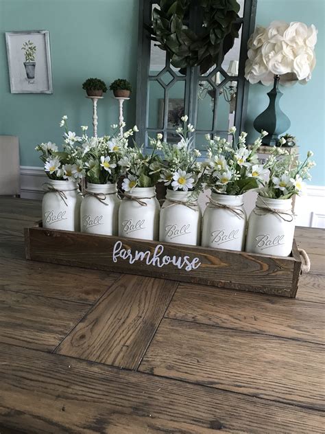 This decor style is very comfortable and homey, and farmhouse dining tables often feature natural wood or distressed paint, as well as spindle legs or trestles. Farmhouse mason jar centerpiece | Country farmhouse decor ...