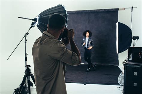 Photographer Doing A Photo Shoot In A Studio Stock Photo Download