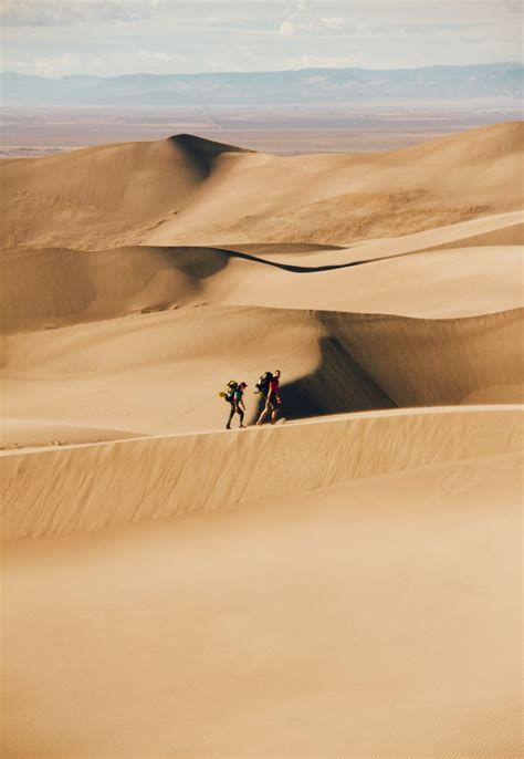 People Walking In The Desert During Daytime Photo Free Desert Image