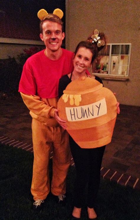 A Man And Woman Are Dressed Up As Winnie The Pooh From The Disney Movie