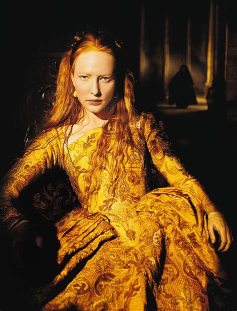 A Woman With Long Red Hair Sitting Down