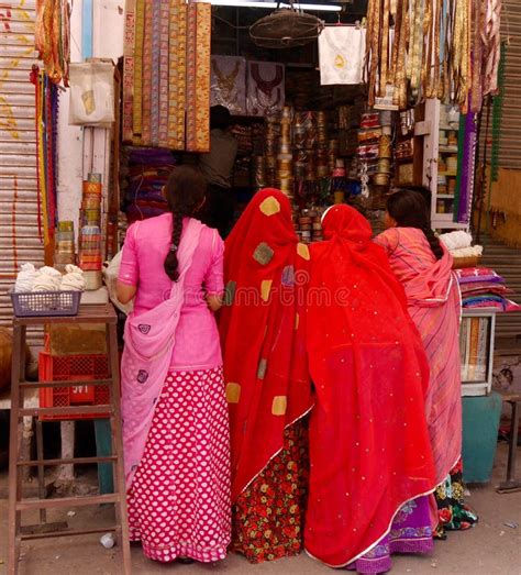 Back View Of Row Of Women In Colourful Saris At Stall Northern India