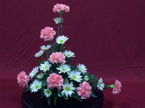 Maybe you would like to learn more about one of these? Asymmetrical Triangle Arrangement - Hannah's Floral Design