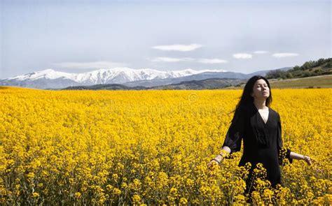 A Beautiful Girl In A Black Dress Stands In The Field Spring Photos