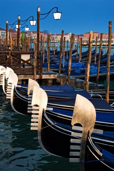 Venice Gondolas Or Gondole On Sunset And Church On Background Italy