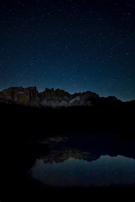 Breathtaking Scenery Of The Starry Sky And Rocky Cliffs Reflecting On