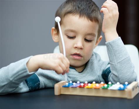 Boy Is Playing A Musical Instrument Stock Photo Image Of Blocks