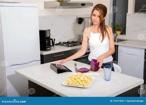 Redhead Girl Slicing In Kitchen Touching Tablet Pc Stock Image Image
