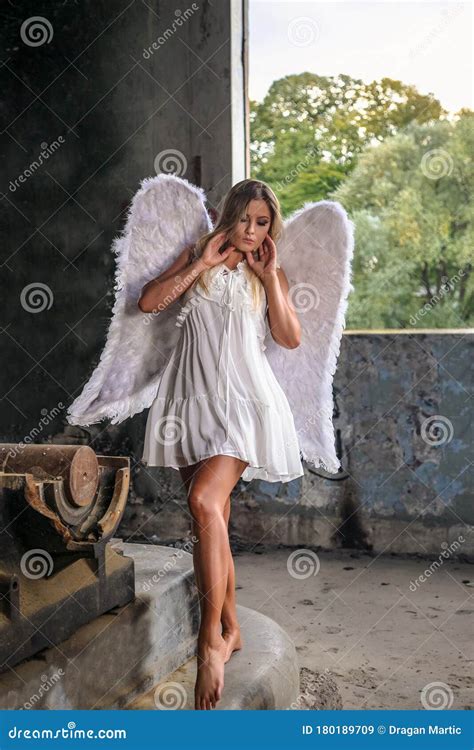 Portrait Of Beautiful Woman With White Angel Wings On Stock Image