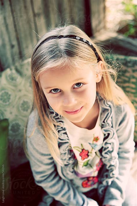 Young Blonde Hair Blue Eyed Girl Looking Up At The Camera By Leigh Love Stocksy United