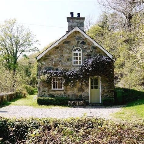 An Old Stone House With Ivy Growing On It