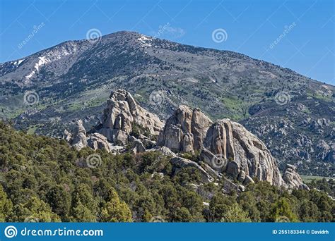 Distant Mountains Form A Backdrop Behind Rock Formations At Castle