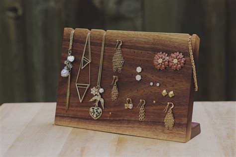 A Wooden Display With Various Jewelry On It