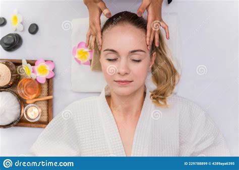 Beautiful Young Woman Sleeping And Relaxing With Face Massage And Treatment In Spa Salon Stock