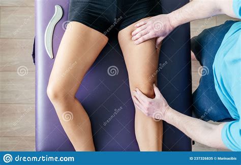 Osteopath Performing Myofascial Release For Quadriceps Stock Image