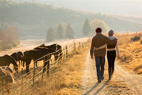 Young Couple Walking In Farm Road Stock Photo Download Image Now Istock