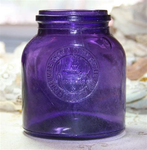 A Purple Glass Jar Sitting On Top Of A Table