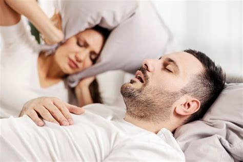 Premium Photo A Man Snoring And Sleeping In The Bed While Woman Is Annoyed Of It