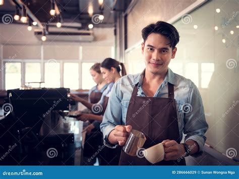 Young Barista Adept in Champion Coffee Brewing, Creating Latte Art in a