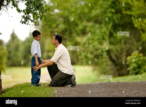Young Boy Facing His Kneeling Father Stock Photo Alamy