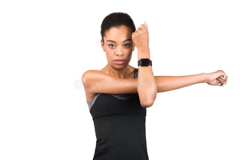 Determined Black Lady Exercising Doing Deltoid Arm Stretch In Studio