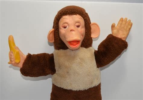 Old Stuffed Monkey With Banana In Hand Banana Poster