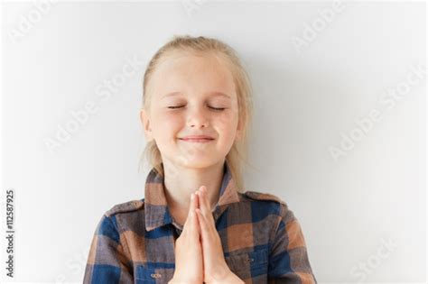 Pretty Little Girl With Closed Eyes Smiling And Meditating With Happy