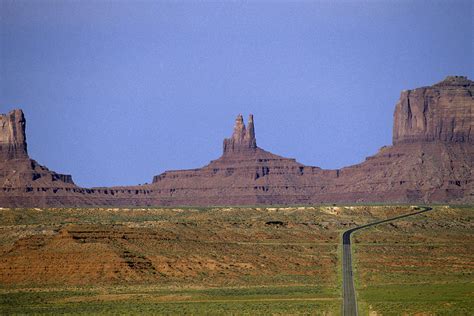 Highway 163 Leading Into Monument Valley With Rock Formations In