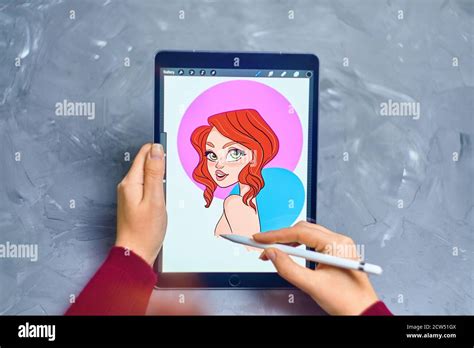 Woman Illustrator Draws A Portrait Of A Girl On An Ipad Pro In